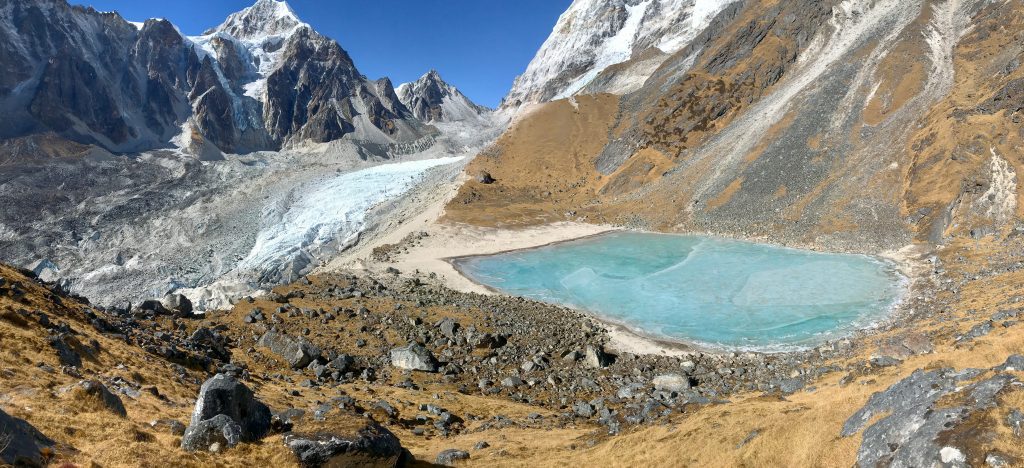 View of a mountain lake, with a rock in the foreground where a camera trap will be attached