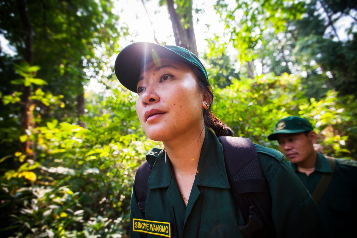 Photograph of Singye Wangmo walking through Bhutan’s Royal Manas National Park with her team of tiger protectors