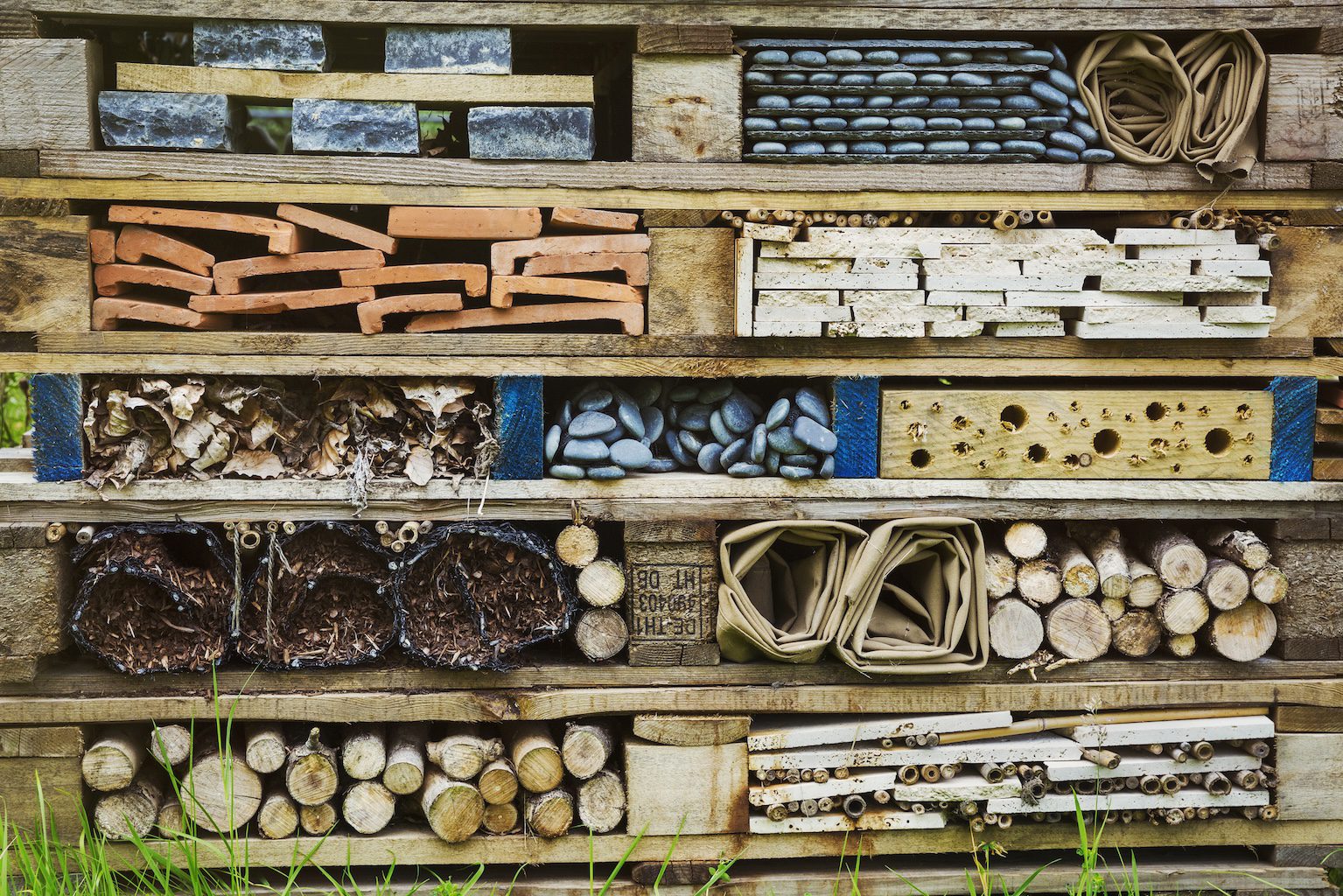 Close-up of large bug house with several layers of different materials.
