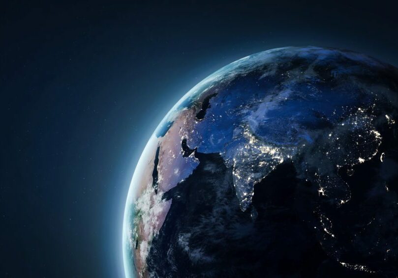 Earth seen from space during Earth Hour, with most of the planet in darkness