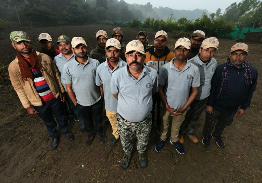 The Tiger Friends pose for a team photo, wearing 'Bagh Mitra' caps and shirts.